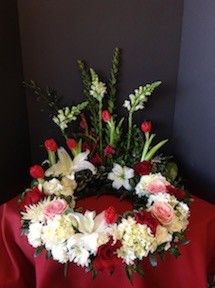 Funeral Flowers Around The Urn with Red Tulips